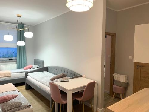 a living room with a couch and a table at Apartamenty Dobranocka in Krotoszyn