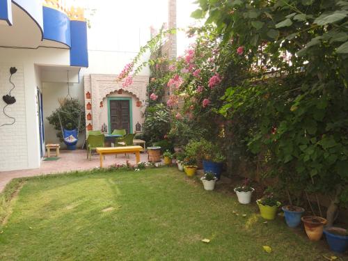 a garden with a bench and some plants at Coral Country Homestay in Agra