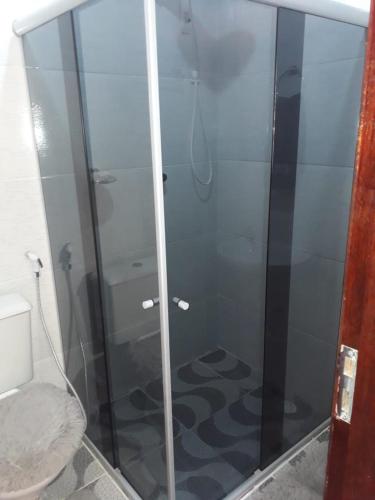 a shower with a glass door in a bathroom at Recanto Novo Horizonte in Recife