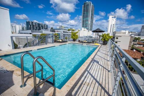 a swimming pool on the balcony of a building with a city skyline at Riviera Suites in Miami Beach