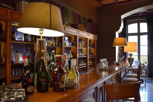 a bar in a restaurant with bottles of wine at Domaine de Joinville in Eu