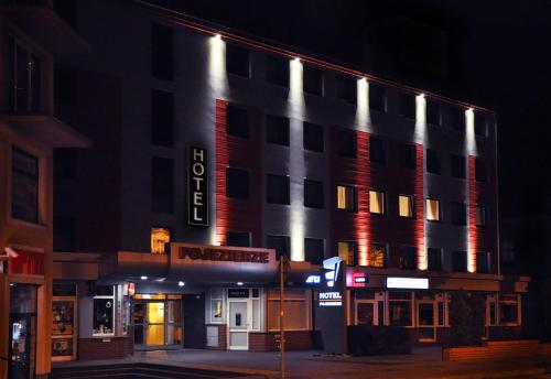 a building with a hotel sign on it at night at Hotel Pojezierze in Szczecinek
