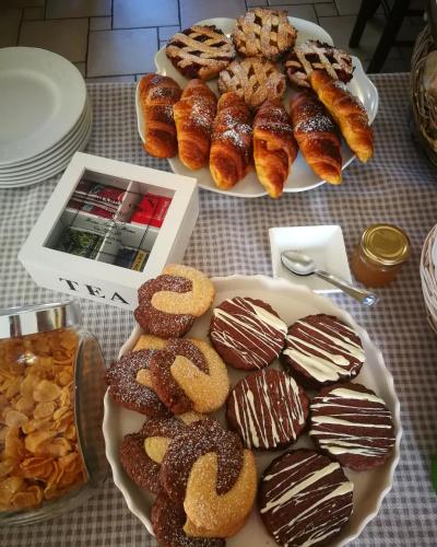 two plates of donuts and other pastries on a table at B&B Del Viale in Bacu Abis