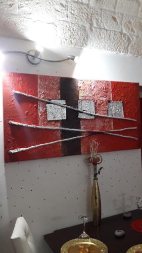 a painting of three boats on a wall at Stunis Buze Suite in Ostuni