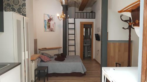 Habitación pequeña con cama y escalera en PLAZA REDONDA brugada home, en Valencia