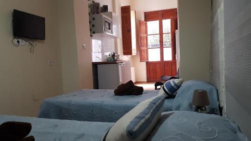 Кровать или кровати в номере PLAZA REDONDA brugada home