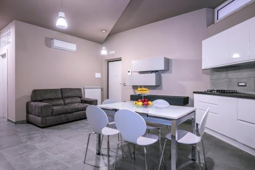 a kitchen and living room with a table and chairs at Eracle Hotel in Volla