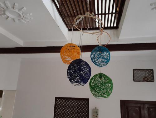 a group of pots hanging from a ceiling at Vidhya Haveli in Pushkar