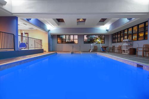 a large swimming pool in a building at Wingate by Wyndham Oklahoma City Airport in Oklahoma City