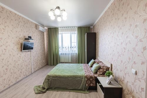 Postel nebo postele na pokoji v ubytování Апартаменты c видом на стадион и парк у Парка Краснодар