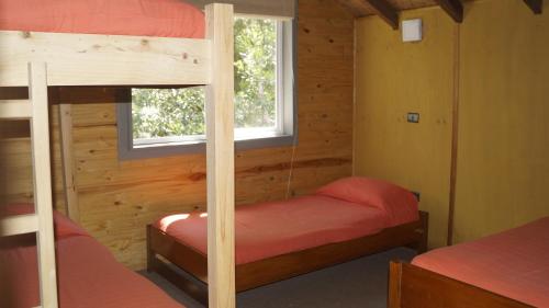 Säng eller sängar i ett rum på Posada de Expediciones Kahuel