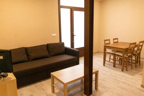 a living room with a couch and a table at CASA CAL METGE in Benissanet