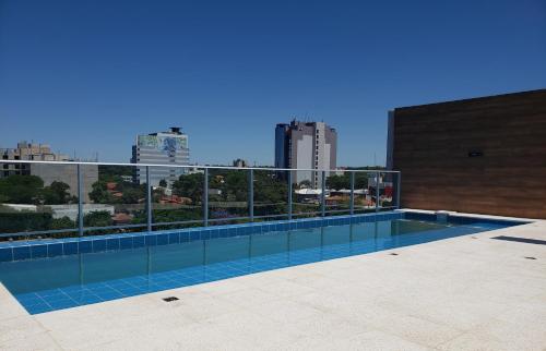 a swimming pool on the roof of a building at START Villa Morra Rent Apartments in Asuncion