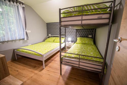 a bunk bed room with two bunk beds in it at Holiday Home with Hot tub and Sauna Sabina in Rovte