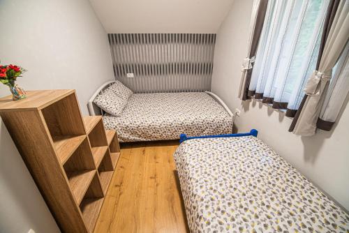 a small room with two beds and a table at Holiday Home with Hot tub and Sauna Sabina in Rovte