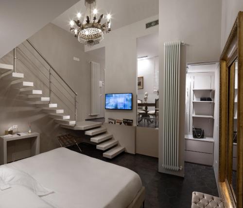 a bedroom with a staircase with a bed and a television at Hotel Villa Taormina in Taormina