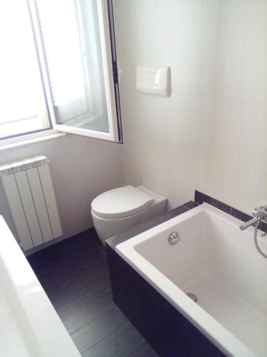 a bathroom with a toilet and a bath tub at PESCARA HOME anto in Pescara