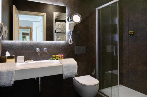 a bathroom with a sink and a toilet and a shower at Hotel Villa Taormina in Taormina