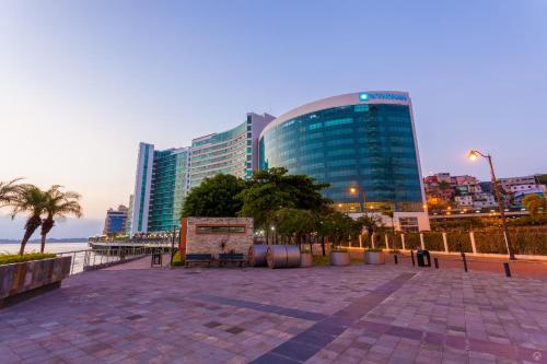 a city with tall buildings next to the ocean at Wyndham Guayaquil, Puerto Santa Ana in Guayaquil