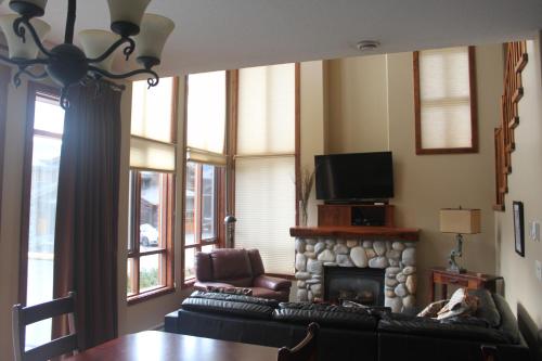 a living room with two couches and a fireplace at Woodhaven # 8 in Sun Peaks in Sun Peaks