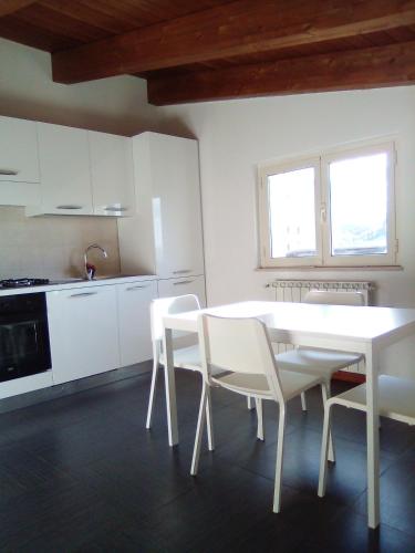 a white kitchen with a white table and chairs at PESCARA HOME anto in Pescara