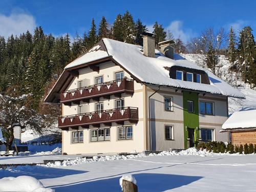 a house with a snow covered roof in the snow at 4 Jahreszeiten in Tamsweg
