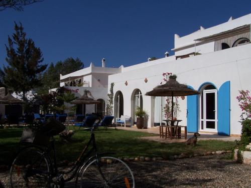 a bike parked in front of a white building at Villa Daba in Ghazoua