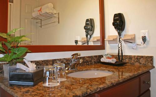 a bathroom counter with a sink and a mirror at Paradise Village in Nuevo Vallarta 