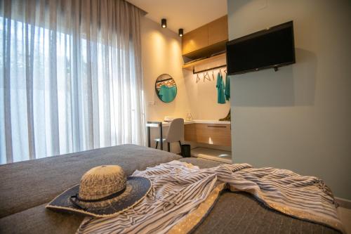 a room with a bed with a hat on it at LENICO Seafront Villa in Agia Pelagia