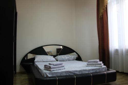 a bedroom with a bed with towels on it at Apartments Domovik ,Kirilla i Mefodiya, 5 in Mukacheve