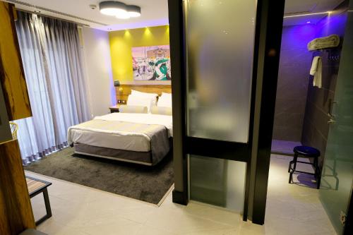 a hotel room with a bed and a bathroom at Royal Court Hotel in Ramallah