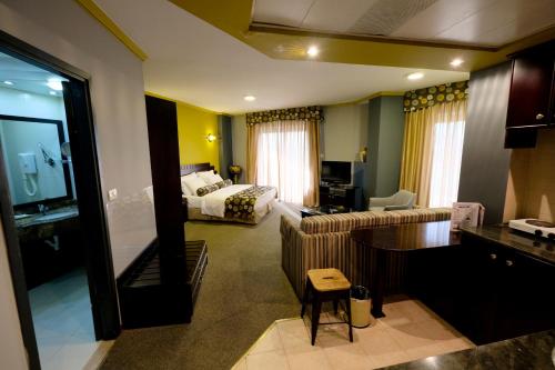 a living room with a couch and a bed at Royal Court Hotel in Ramallah