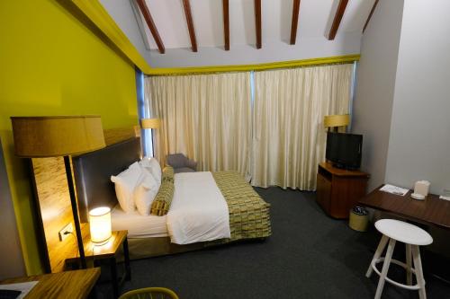a hotel room with a bed and a television at Royal Court Hotel in Ramallah