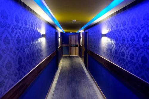 a corridor with blue lights in a building at Royal Court Hotel in Ramallah