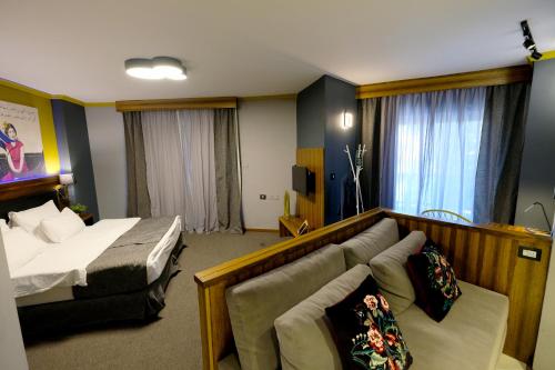a hotel room with a bed and a couch at Royal Court Hotel in Ramallah