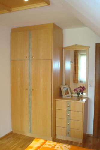 a large wooden cabinet with a dresser in a room at Gästehaus Moser in Ramingstein