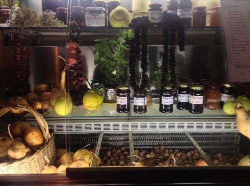a display case with various fruits and vegetables at Hotel Restaurant Bujtina e Gjelit in Tirana