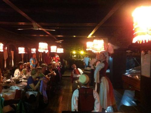 a group of people sitting in a restaurant at Hotel Restaurant Bujtina e Gjelit in Tirana