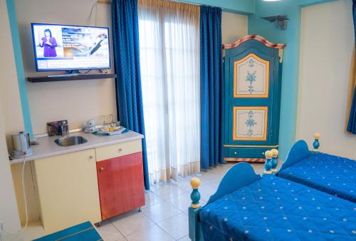 a bedroom with a bed and a sink and a tv at Yiannis Apartments in Ioannina