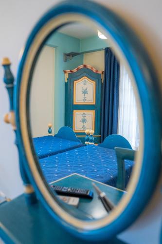 a mirror reflection of a bed in a bedroom at Yiannis Apartments in Ioannina