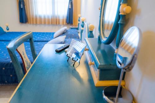 a hospital room with a table and a mirror at Yiannis Apartments in Ioannina