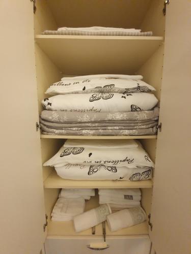 a closet filled with white pillows and towels at Golden Gate Apartment Sarajevo in Sarajevo