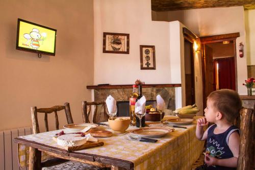 a little boy sitting at a table with a table cloth at Cabañas Tilcara Mia in Tilcara