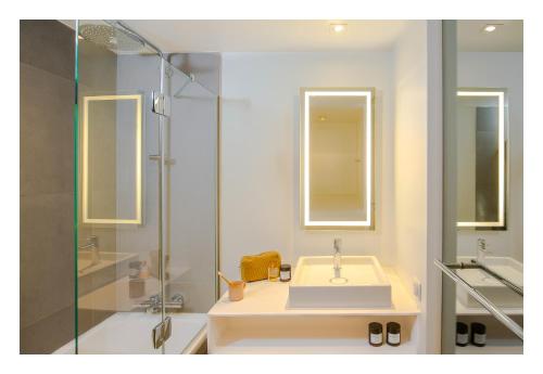 a bathroom with a sink and a shower at Novotel Paris Porte Versailles in Paris
