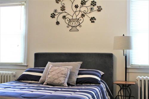 a bedroom with a bed with a vase on the wall at Master Bedroom-Private Bath, Washington DC in Washington, D.C.