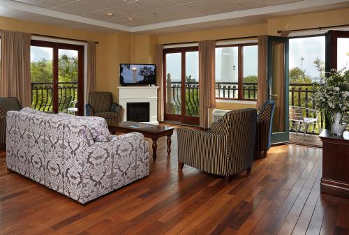 a living room with a couch and a fireplace at Ocean Inn & Suites in Saint Simons Island
