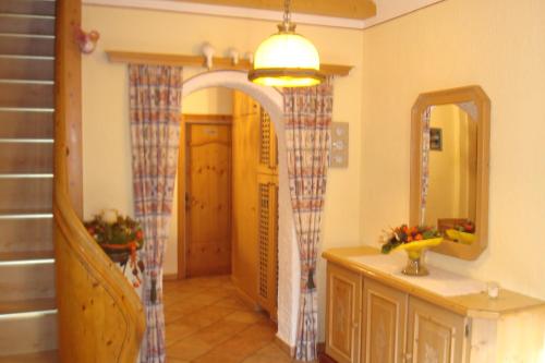 a bathroom with a vanity and a mirror and a sink at Gästehaus Moser in Ramingstein