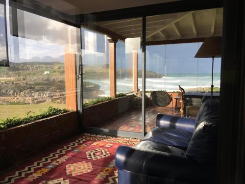 a living room with a couch and a view of the ocean at La Lagartija Adults Only in Ajo