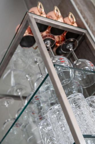 a bunch of glasses in a glass case at Residence Villa Rosa in Garda