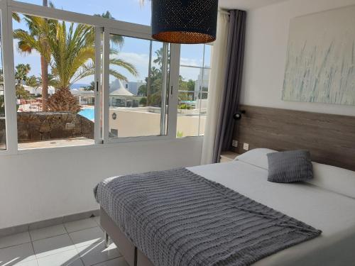 Postel nebo postele na pokoji v ubytování Luxury Apartamento Luz de Mar Complejo Playa Roca